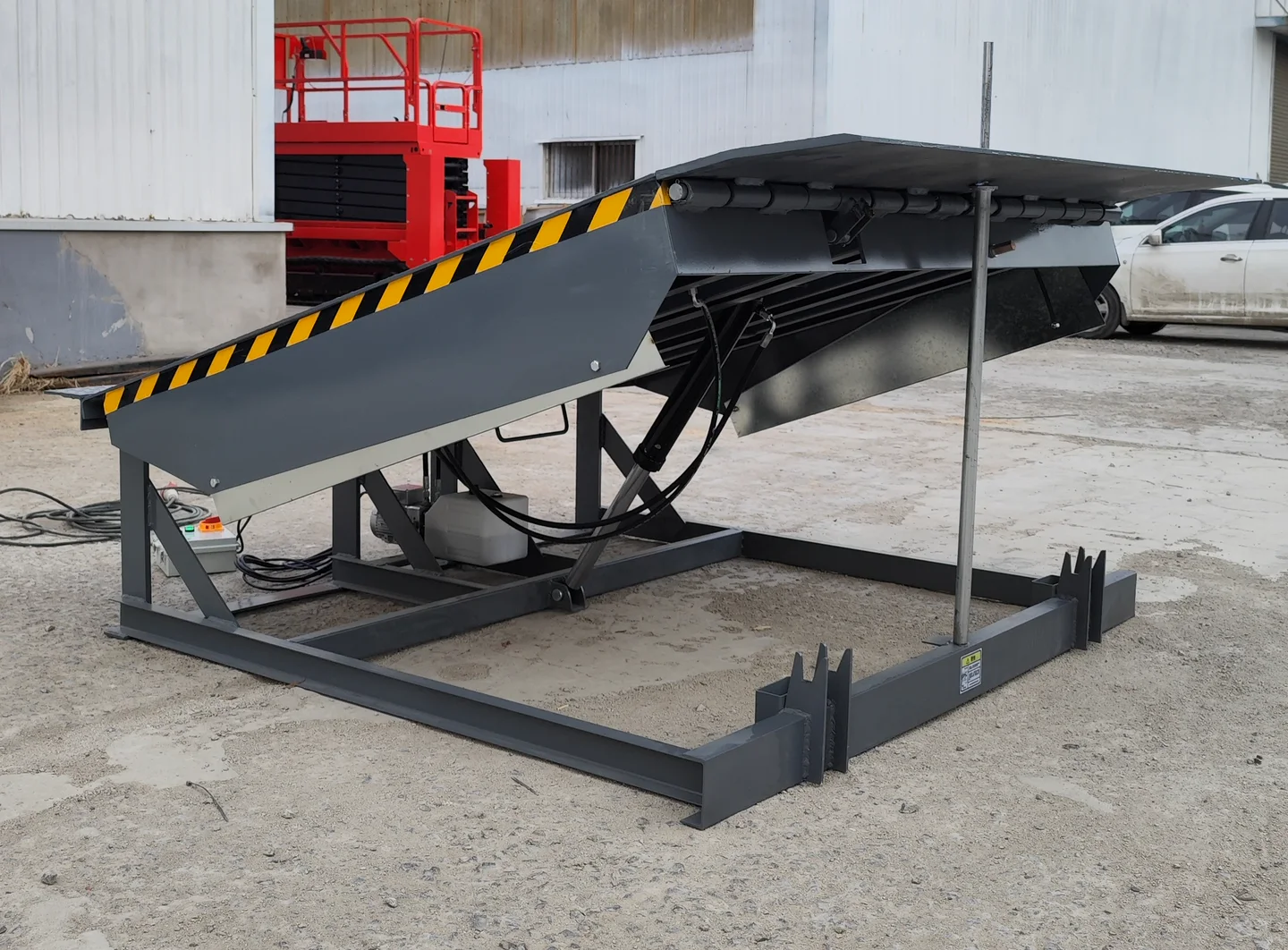 Complete standard fixed hydraulic dock leveler raised in a three-quarter view